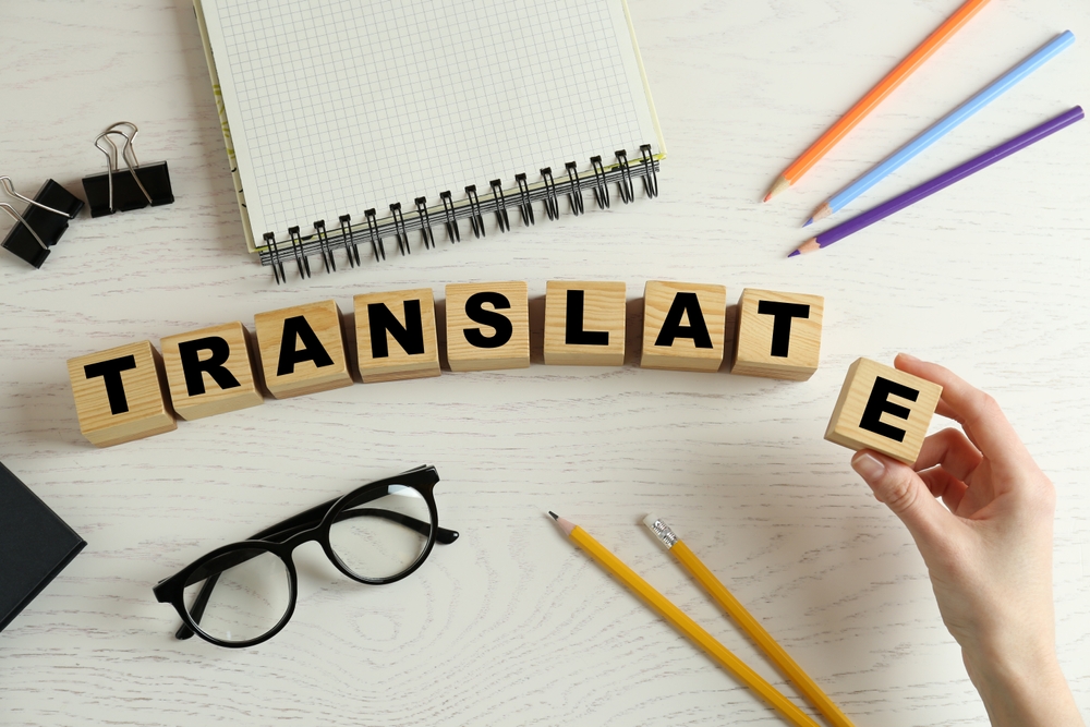 Woman making word translation with wooden cubes