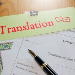 Red translation text over English Official Translation paperwork