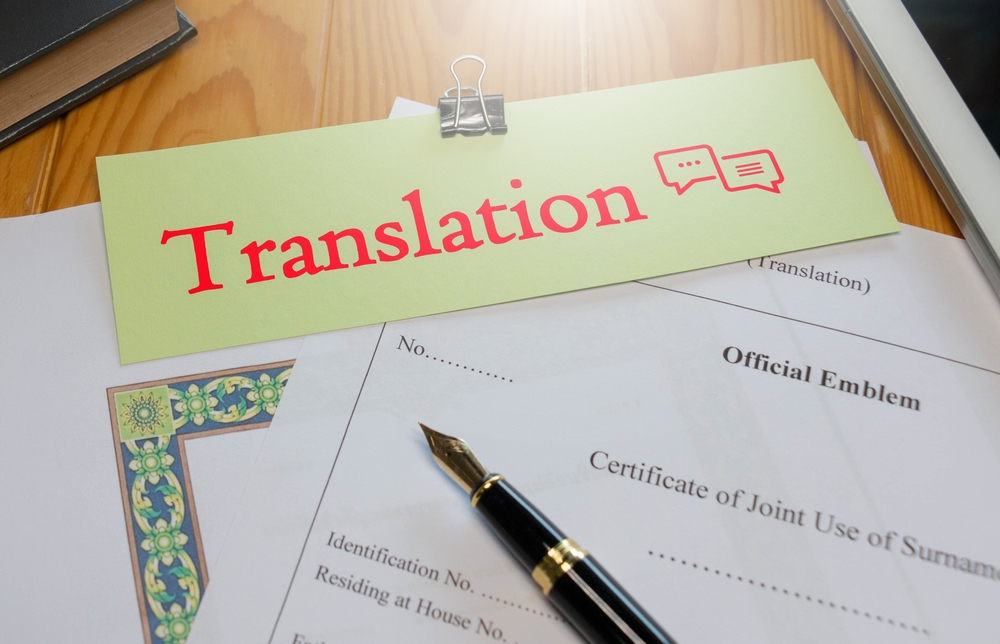 Red translation text over English Official Translation paperwork