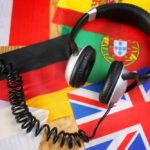 Language course headphone and flag on a table